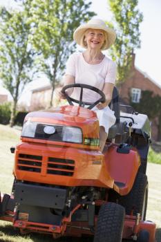 Royalty Free Photo of a Woman on a Riding Lawn Mower