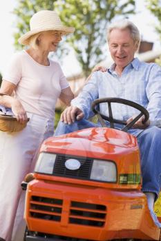 Royalty Free Photo of a Couple With a Riding Mower