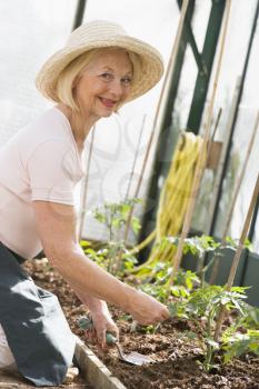 Royalty Free Photo of a Woman in a Greenhouse