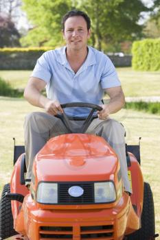 Royalty Free Photo of a Man on a Lawn Mower