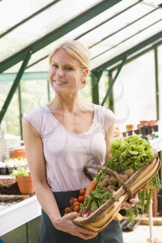 Royalty Free Photo of a Woman With a Basket of Vegetables