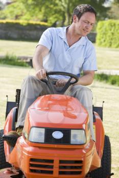 Royalty Free Photo of a Man on a Riding Mower