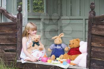 Royalty Free Photo of a Girl Having a Tea Party