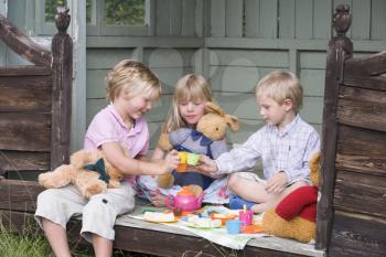 Royalty Free Photo of Three Children Having a Tea Party