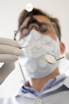 Royalty Free Photo of a Dentist With a Pick and Mirror