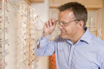 Royalty Free Photo of a Man Trying on Eyeglasses