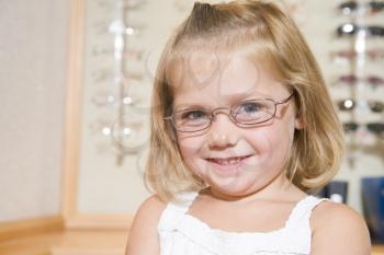 Royalty Free Photo of a Little Girl Trying on Eyeglasses