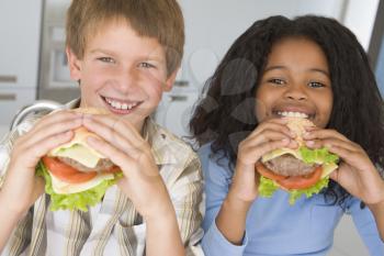 Royalty Free Photo of Children Eating Burgers