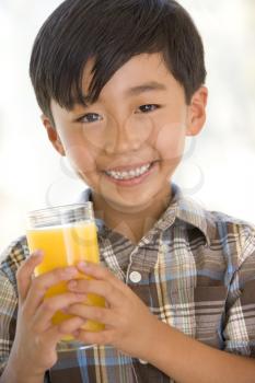 Royalty Free Photo of a Boy Drinking Orange Juice