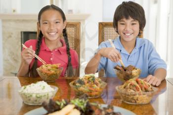 Royalty Free Photo of Two Children Eating Chinese Food