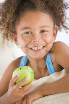 Royalty Free Photo of a Girl Eating an Apple