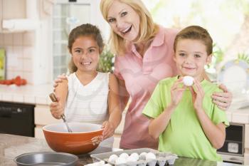 Royalty Free Photo of a Mother and Two Children Baking