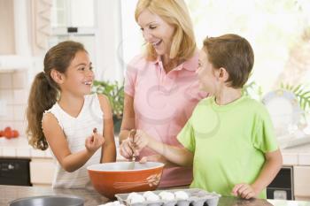 Royalty Free Photo of a Woman and Two Children Baking
