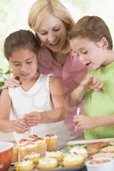 Royalty Free Photo of a Woman Baking With Two Children