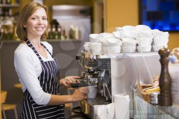 Royalty Free Photo of a Woman Making Coffee