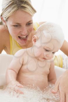 Royalty Free Photo of a Mother Giving a Baby a Bath