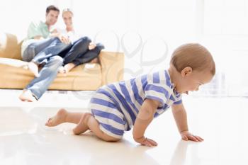 Royalty Free Photo of a Couple at Home With the Baby Playing on the Floor