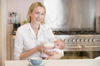 Royalty Free Photo of a Mother Feeding a Baby