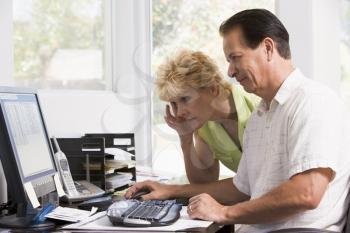 Royalty Free Photo of a Couple Frowning at a Computer