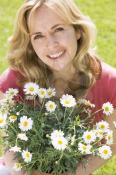 Royalty Free Photo of a Woman With a Bouquet of Daisies