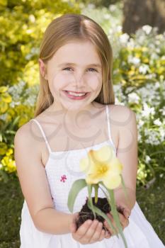 Royalty Free Photo of a Young Girl Holding a Flower