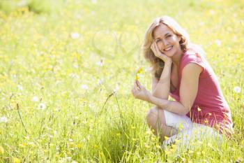 Royalty Free Photo of a Woman in a Field of Wildflowers