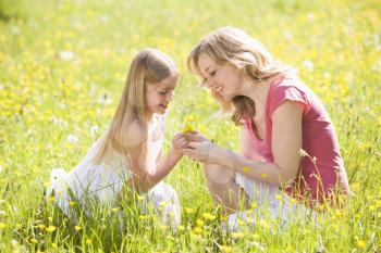 Royalty Free Photo of a Mother and Daughter With Flowers