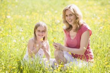 Royalty Free Photo of a Mother and Daughter Picking Flowers