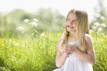 Royalty Free Photo of a Child Picking Flowers
