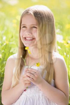Royalty Free Photo of a Little Girl With a Buttercup