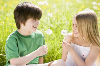 Royalty Free Photo of a Boy and Girl With Dandelions