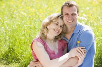 Royalty Free Photo of a Couple Beside a Meadow