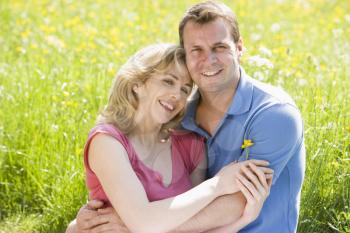 Royalty Free Photo of a Couple By a Meadow