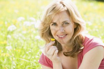 Royalty Free Photo of a Woman Holding a Buttercup