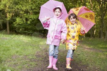 Royalty Free Photo of Two Girls With Umbrellas