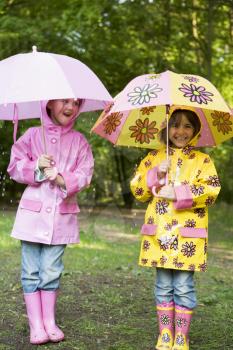 Royalty Free Photo of Two Girls With Umbrellas