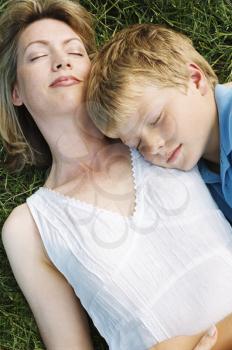 Royalty Free Photo of a Mother and Son Asleep on the Grass