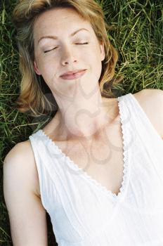 Royalty Free Photo of a Woman Lying on the Grass