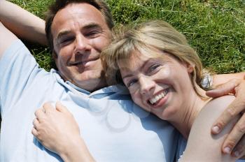 Royalty Free Photo of a Couple Lying on the Lawn