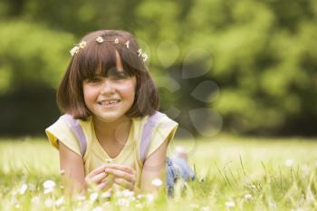 Royalty Free Photo of a Little Girl Lying in the Grass