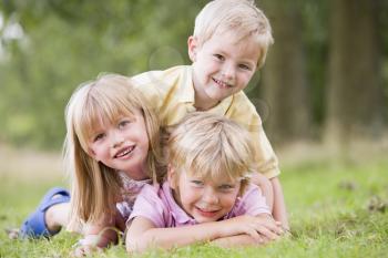 Royalty Free Photo of Three Children Playing Outside