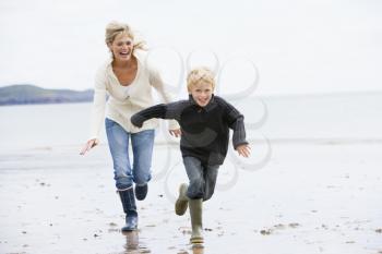 Royalty Free Photo of a Mother and Son Running on a Beach
