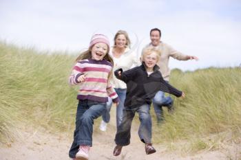 Royalty Free Photo of a Family Running at the Beach