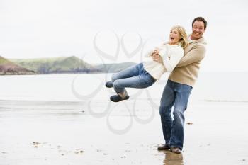 Royalty Free Photo of a Couple Playing on the Beach