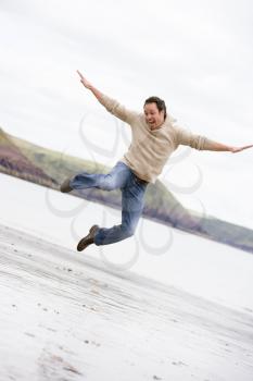 Royalty Free Photo of a Man Jumping on a Beach