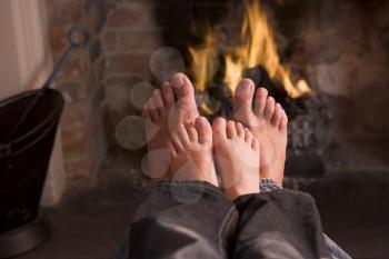 Royalty Free Photo of a Father and Son's Feet at a Fire