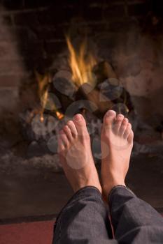 Royalty Free Photo of Feet Warming at a Fire