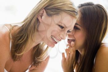 Royalty Free Photo of Two Women Whispering