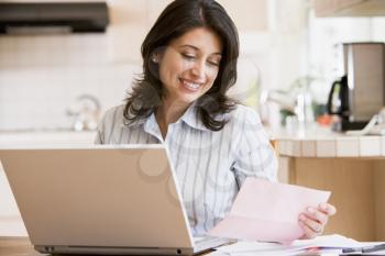 Royalty Free Photo of a Woman Paying Bills on Her Laptop