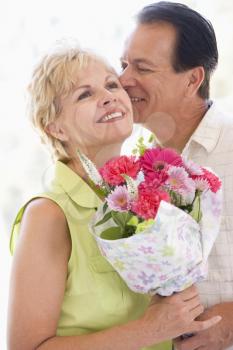 Royalty Free Photo of a Man Giving His Wife Flowers